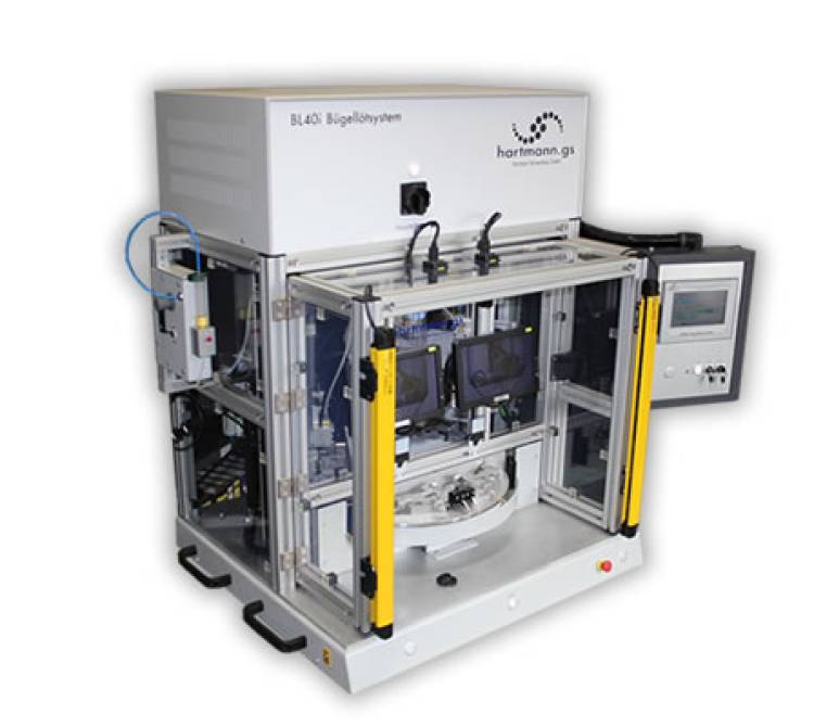 Doppelbügellötsystem mit einem dreifach geteilten Drehteller.